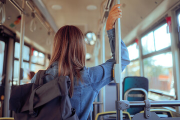 Woman in a Bus with Backpack Travelling as Tourist. Travel girl riding public bus tour...