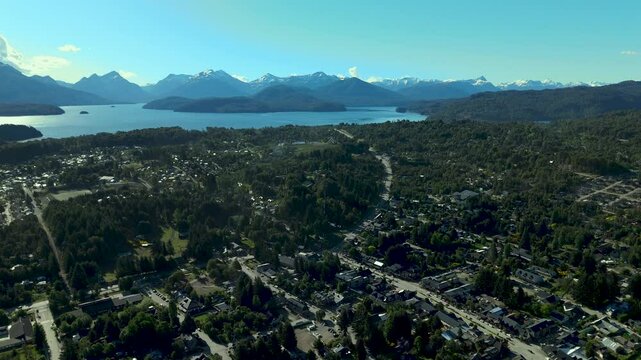 Scenic aerial view of Villa La Angostura's main urban area featuring Arrayanes Avenue. Nestled in Patagonia, Argentina, the image captures the charming blend of urban development and surrounding.