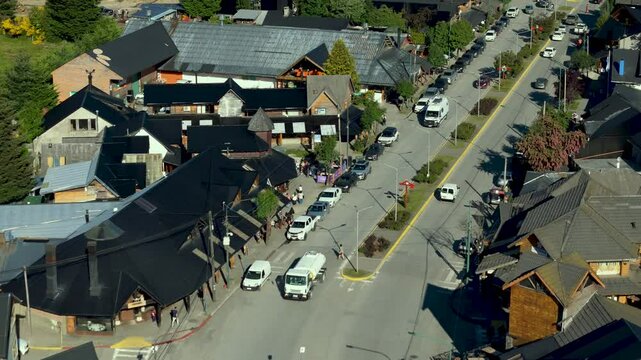 Scenic aerial view of Villa La Angostura's main urban area featuring Arrayanes Avenue. Nestled in Patagonia, Argentina, the image captures the charming blend of urban development and surrounding.