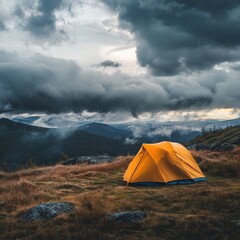 Obraz premium Solo Tent Set Against Majestic Mountain Landscape Under Dramatic Cloudy Sky at Dusk, Perfect for Camping and Outdoor Adventures, Nature Escape