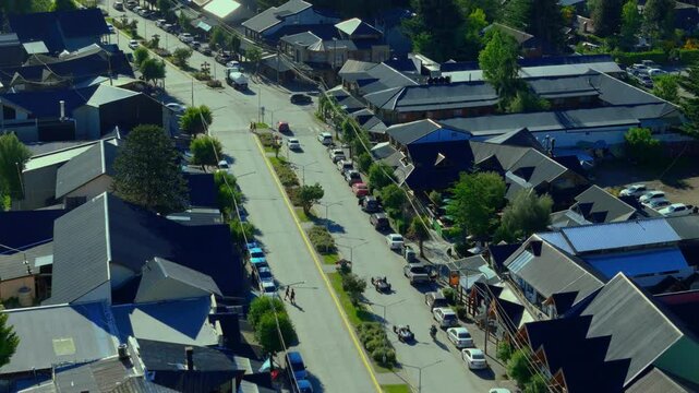 Scenic aerial view of Villa La Angostura's main urban area featuring Arrayanes Avenue. Nestled in Patagonia, Argentina, the image captures the charming blend of urban development and surrounding.