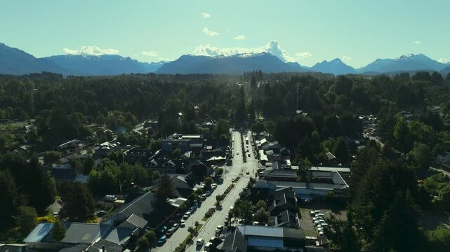 Scenic aerial view of Villa La Angostura's main urban area featuring Arrayanes Avenue. Nestled in Patagonia, Argentina, the image captures the charming blend of urban development and surrounding.