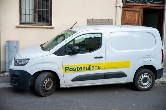 White citroen berlingo van parked on street for poste italiane mail and parcel delivery service