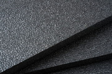 Top view of grey thermal insulation styrofoam sheets stacked on top of each other