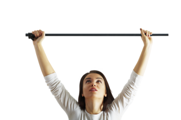 Woman holding a long bar with both hands raised above her head, wearing a white shirt, isolated on a white background, concept of strength