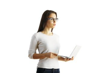 A woman in a white top holding a laptop, standing with a focused expression, isolated on a white background. Concept of technology and work