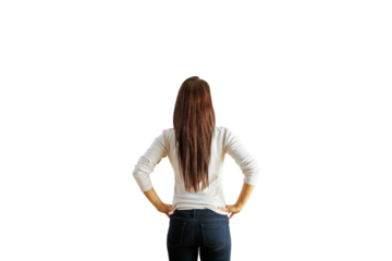 Woman with long brown hair, wearing casual clothing, viewed from the back, standing with hands on hips on isolated white background, concept of contemplation
