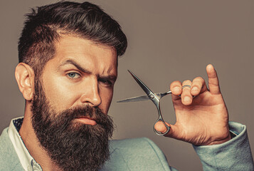 Man holding scissors. Barber scissors. Barber scissors, vintage barbershop