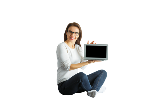 Female sitting cross-legged, holding a laptop with a blank screen, wearing casual clothes, isolated on white background, technology concept