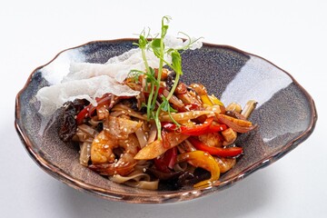 Stir-Fried Udon with Meat in Wok on a Plate Against a White Background
