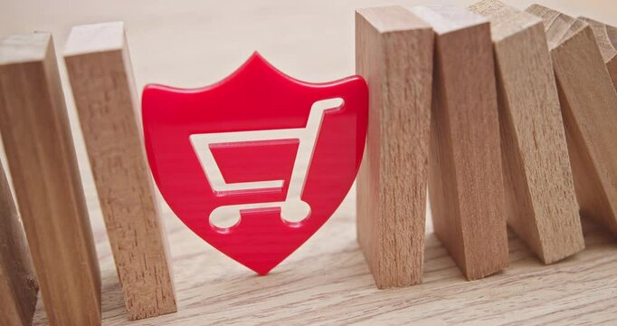 E-commerce and consumer protection, data privacy, and online shopping security : A shield with a shopping cart icon stands between two rows of wooden blocks, depicting the importance of data privacy.