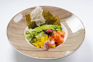  Salmon Poke Bowl with Cucumber, Nori, Beans, and Avocado Against a White Background