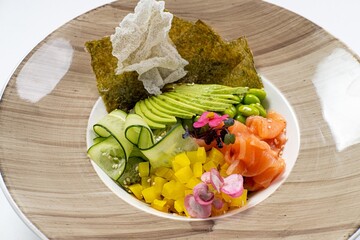  Salmon Poke Bowl with Cucumber, Nori, Beans, and Avocado Against a White Background