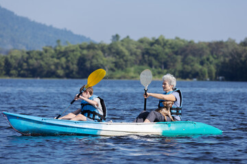 Grandmother and Grandson Kayaking with Their Dog on a Scenic Lake, Enjoying a Day Outdoors, Blue Waters, Sunny Day, Family Bonding, Adventure and Exploration in Nature, Peaceful and Relaxing Time