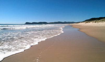 Obraz premium Serene beach scene, soft sand, gentle waves, clear water, evokes tranquility