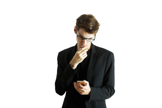 A man wearing asuit and glasses holding a smartphone, looking thoughtful on a white background. Concept of decision-making or focus