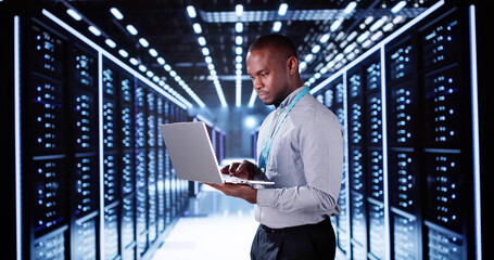 Fototapeta premium Happy Engineer In Data Center Server Room Configuring AI