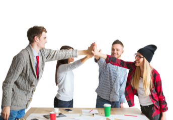 Team of four smiling young adults collaborating, giving a group high-five over a desk, isolated on a white background, concept of teamwork