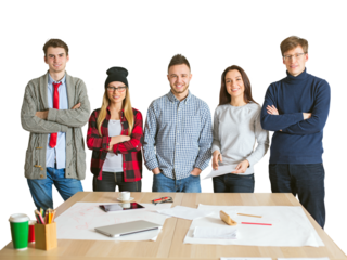 Young team of five people standing confidently behind a desk with papers, laptop, and stationery, isolated on a white background. Teamwork concept
