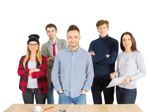 A group of young professionals standing together, smiling confidently near a table. Isolated on a white background. Concept of teamwork and collaboration