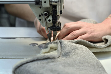 sewing factory sew fabric seamstress knitwear wool hands toy slippers red sewing machine iron ironing blue pattern templates needles carpets scissors cut lamp