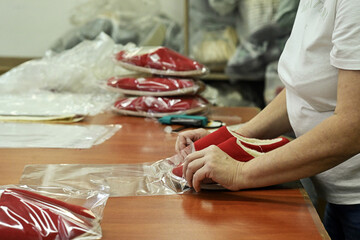 sewing factory sew fabric seamstress knitwear wool hands toy slippers red sewing machine iron...