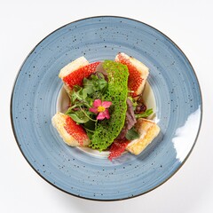  Asian Salad with Tofu and Edible Flower on a Plate Against a White Background