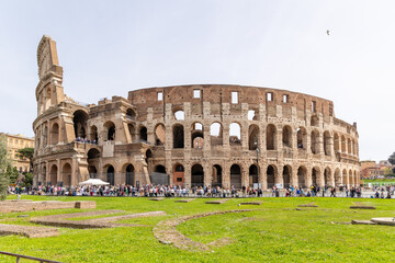 Rome, Italy - April 09, 2024: Ruins of the Coliseum with tourists strolling among the archaeological remains in Rome, Italy