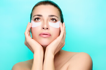 Woman enjoying beauty treatment with eye patches in spa setting