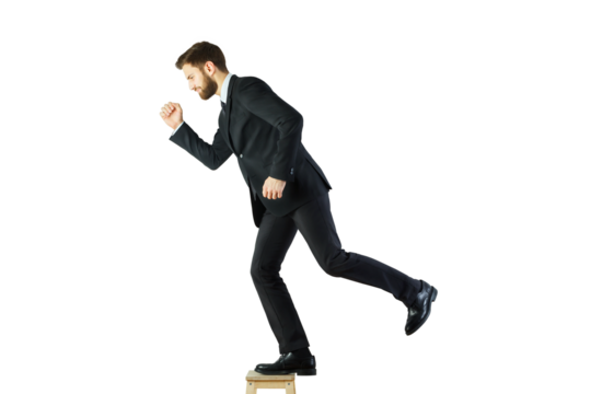Businessman in a suit stepping off a wooden stool, isolated on a clean white background. Concept of risk, leadership, and moving forward