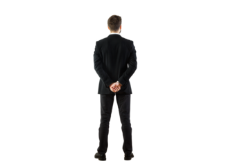Rear view of a businessman in a formal suit standing with hands clasped behind his back, isolated on a clean white background. Professional concept