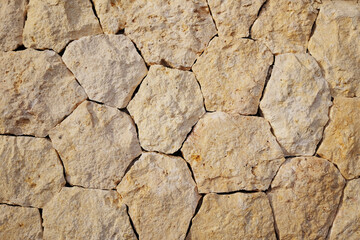 Rough fragment stone wall texture or stone paving cobblestones background