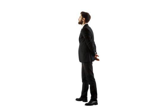 A man in a formalsuit standing in profile, hands clasped behind his back, on a white background. Business concept