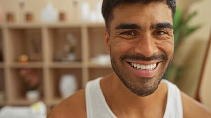 Handsome man smiling in a wellness spa room with a bright and inviting interior