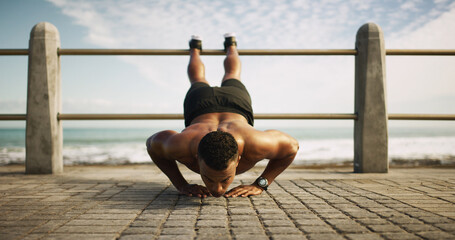 Fitness, man and push up at ocean for exercise, balance and upper body workout. Bodybuilder,...