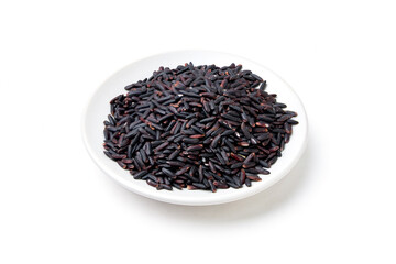 Pile of Riceberry place on white plate isolated on white background. Riceberry (Oryza sativa) is a dark purple glutinous rice that is aromatic, nutritious high.