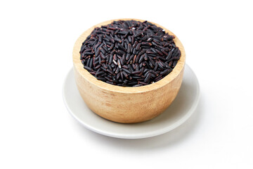 Riceberry in wooden bowl isolated on white background. Riceberry (Oryza sativa) is a dark purple glutinous rice that is aromatic, nutritious high.