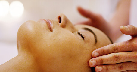 Naklejka premium Girl, therapist hands and head massage in spa for relax, sleeping or skincare treatment at luxury hotel. Peace, client closeup or masseuse in resort for tension relief, stress management or self care