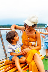 Fototapeta premium Mother and son tourists on a boat on Lake Titisee in the Black Forest, Germany