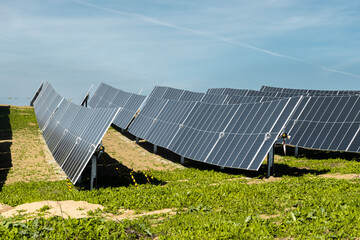 Solar panels in a lush green field generating sustainable eco-friendly energy