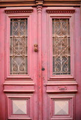 A vintage wooden pink door in Lefkara village Cyprus.