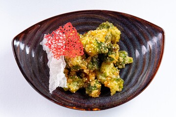 Deep-Fried Vegetables on a Plate Against a White Background