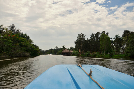 An old blue boat traveling in the tropical river of Guam&aacute; Cuba.
