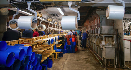 Glass fiber production workshop showcasing machinery and workers during manufacturing process in an...