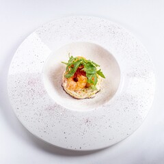 Arugula Salad with Shrimp on a White Plate Against a White Background