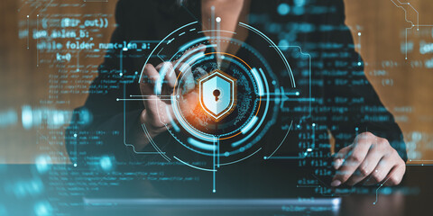 Woman interacting with digital security interface featuring lock and shield hologram.