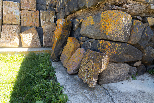 Weathered stones and detailed carvings at Sevanavank monastery reflect centuries of history under beautiful sunlight.