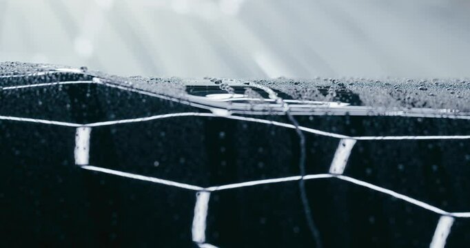 Witness the ultimate in paint protection as water beads up and runs off a car's surface. This close-up shot demonstrates the effectiveness of a high-quality wax or sealant.