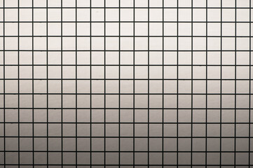 metal grid with square cells on gray background with gradient