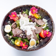 Hot Pan-Asian Salad with Meat, Egg, Greens, and Flower Garnish